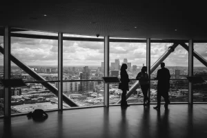people by building window black and white